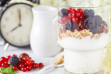 Healthy light breakfast: parfait with muesli, berries and yogurt.