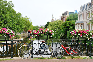 Fototapeta na wymiar Amsterdam, Holland - bicycles and flowers over a bridge