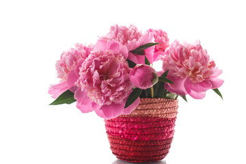 bouquet of pink peonies in a wicker vase