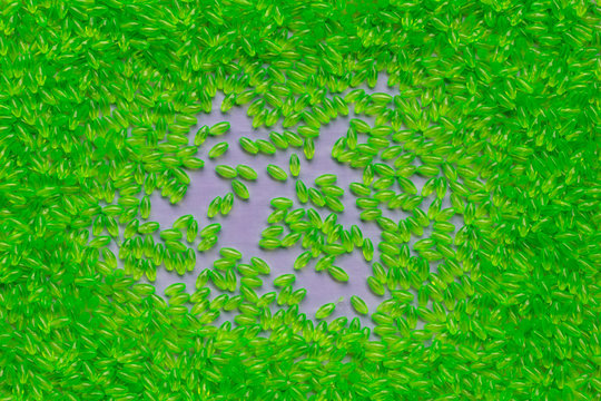 Background of green round oval plastic pellets.