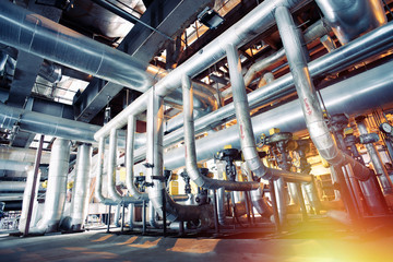 Equipment, cables and piping as found inside of a modern industrial power plant