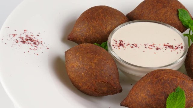 Arabic cuisine, meat appetizer kibbeh, minced meat and bulghur wheat, fried snack, loop, 4K, ProRes codec, 422 HQ, ISO 100