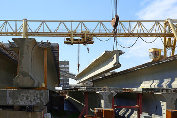 The concrete structure raise the crane on blue sky background © sergasx