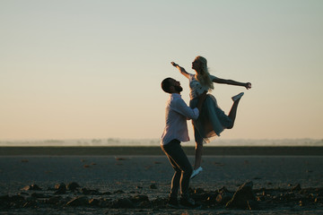 Man and a balerina dancing on the beach © 4Max