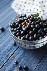 Black currant bowl on the wooden table