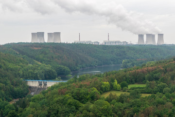 Fototapeta na wymiar Two power plants, hydro powerplant in the valley and nuclear power plant on the horizon