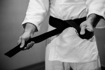 Aikido black belt on white kimono