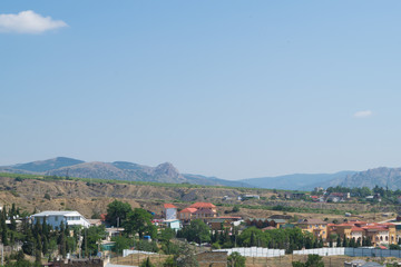 Fototapeta na wymiar View of the seaside town Sudak in Crimea with mountains