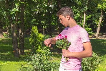 young men waiting date with roses whatching time