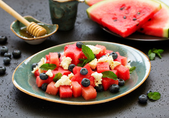 Salad from watermelon, with cheese, berries and mint.