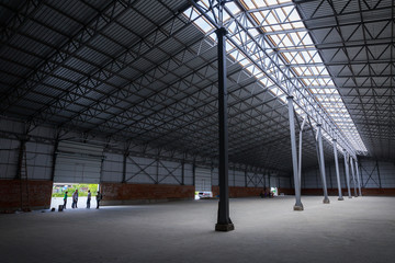 A huge warehouse. Metal construction. Grain dryer. Threshing floor. Blurred-unrecognizable faces of people. Concept theme is the production of food and agricultural production.