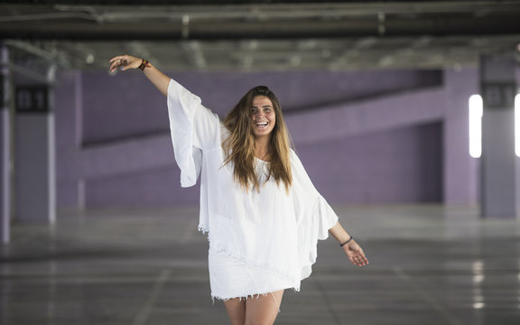 Charming model posing with open arms on parking