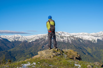 Fototapeta na wymiar Adventurer photographer stands on a rock and meditate