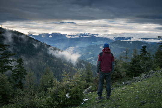 Meditating adventurer admiring epic view of the mountains