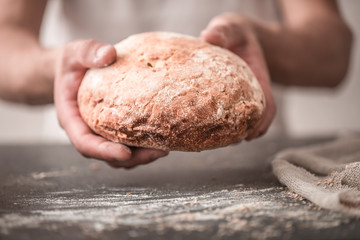 fresh bread in hands closeup on