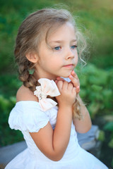 Cute little girl on nature in summer day