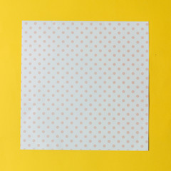 Texture background of fashion pastel colors: rose quartz polka dot and yellow papers in minimal concept. Flat lay, Top view.
