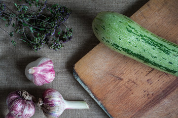 Fresh garlic and zucchini on the background.