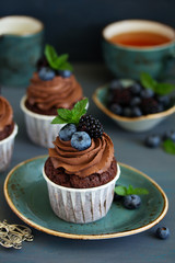 Chocolate cupcakes, with chocolate cream and fresh berries.