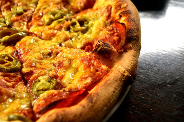 whole italian pizza on wood table with ingredients