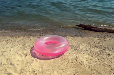 pink pool ring on the beach