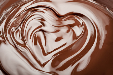 Melted chocolate heart.  Swirl chocolate splash background.