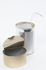 Two shiny empty aluminum food cans