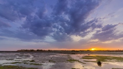 Cloudy Sunset Time lapse Seascape, view of Olhao salt marsh Inlet waterfront to Ria Formosa natural park. Algarve.