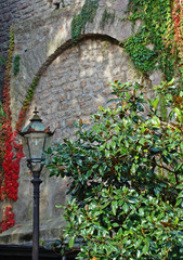 Fototapeta na wymiar Street lamp on stone wall background