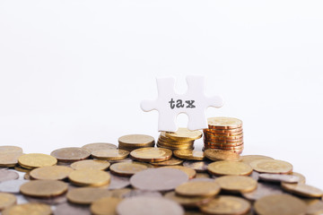 TAX word on White missing puzzle and gold coins with copyspace area