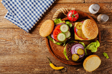 Homemade, beef hamburger with cheese and vegetables.