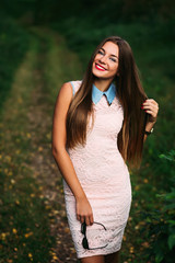 Charming girl with long hair smiling at the camera