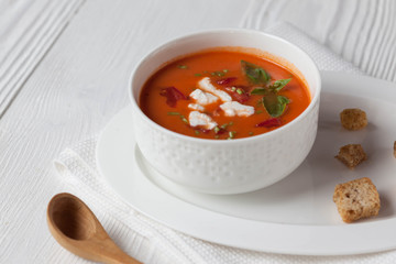 Creamy cheese Tomato Soup on white rustic background