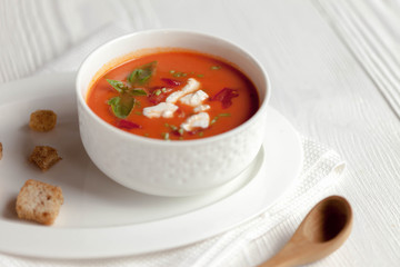 Creamy cheese Tomato Soup on white rustic background