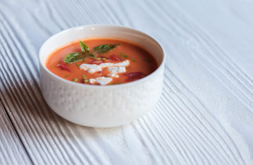 Creamy cheese Tomato Soup on white rustic background