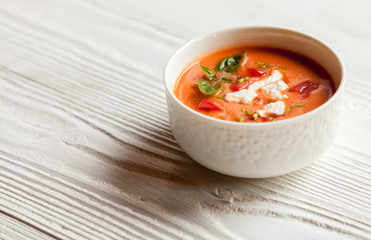 Creamy cheese Tomato Soup on white rustic background