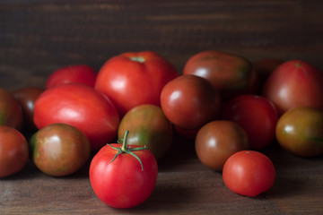 Fototapeta na wymiar fresh ripe tomatoes on a wooden rustic table