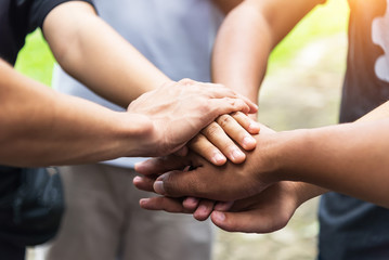 Teamwork concept,Business team standing hands together in the loft office.people joining for cooperation success business,win in every thing,vintage color