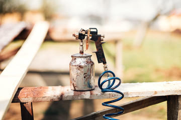 Close up details of spray gun or airbrush in carpentry industry