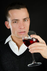 Attractive young man and red wine. 