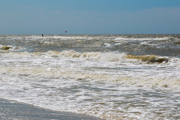 Sea water washes sand on the beach on a sunny day