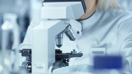 Close-up Shot of Scientist Using Microscope in Laboratory.