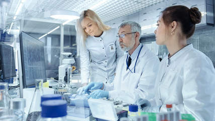 Team of Research Scientists Working With Personal Computer, Analysing Test Trial New Generation...