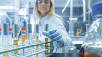 Shot of a Cart with Test-Tubes, Analysis, Beakers and Various Glassware. Scientist Takes Some of...