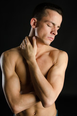 Naklejka premium Young attractive guy. Black background. Studio. 