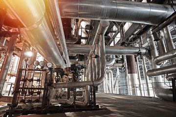 Equipment, cables and piping as found inside of a modern industrial power plant