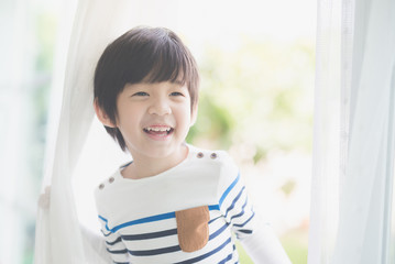 cute Asian child at the open window