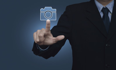 Businessman pressing camera flat icon over gradient blue background, Business camera service concept