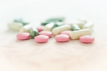 Pink, white and green pills tablets medicine