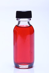Red Liquid in Glass Bottle white cap